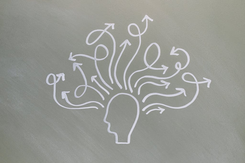 Conceptual chalk drawing illustrating mental health challenges with arrows representing thoughts.